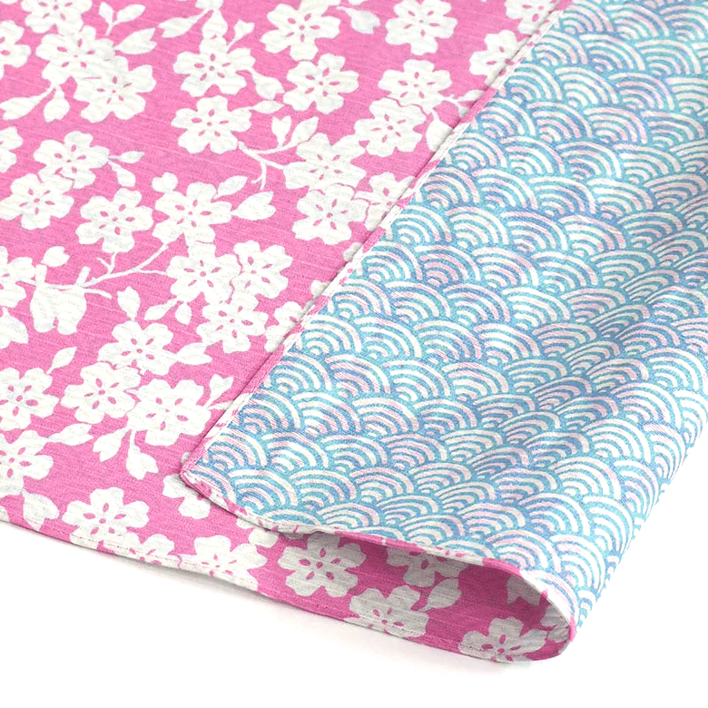 Vändbar japansk furoshiki-tygbit med motiv av körsbärsblom och vågor.